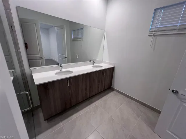 Bathroom with vanity and tile patterned flooring