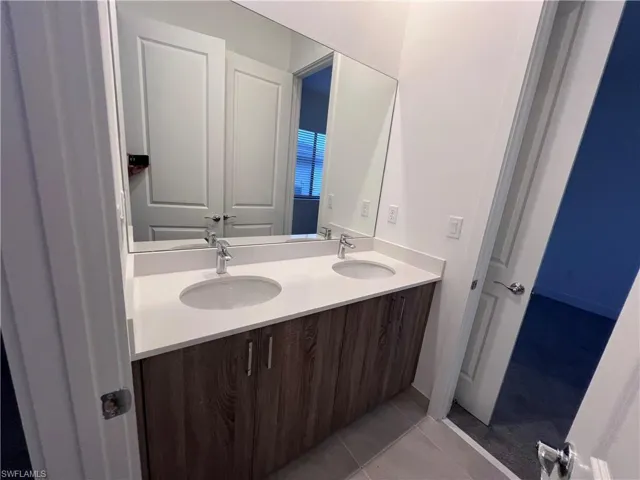 Bathroom with vanity and tile patterned flooring