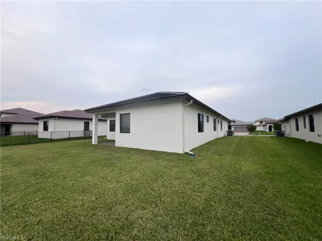 View of side of home with a lawn