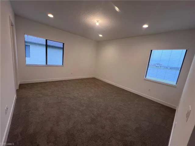 Carpeted empty room with a textured ceiling