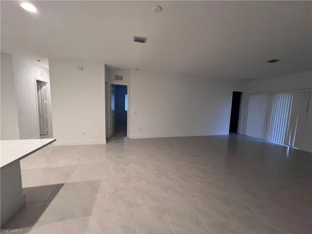 Unfurnished living room featuring light tile patterned floors