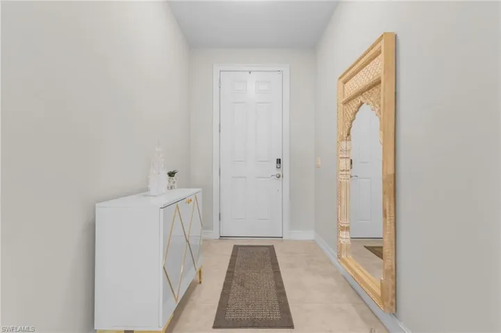 Doorway with light tile patterned floors