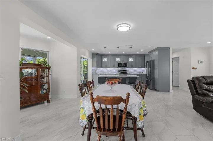 Dining area with marble finish floor, baseboards, and recessed lighting