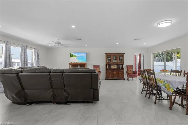 Living room featuring plenty of natural light, visible vents, and recessed lighting