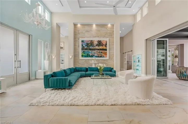 Your entry into this home makes an unforgettable statement, featuring a floor-to-ceiling custom stone-tiled wall beautifully accented with Lalique sconces, stunning lalique lighting, setting a tone of refined elegance from the moment you arrive.