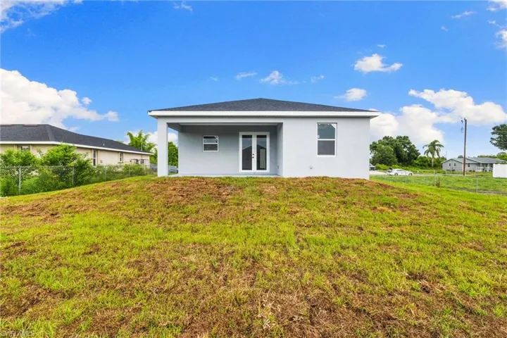 Back of house featuring french doors and stucco siding