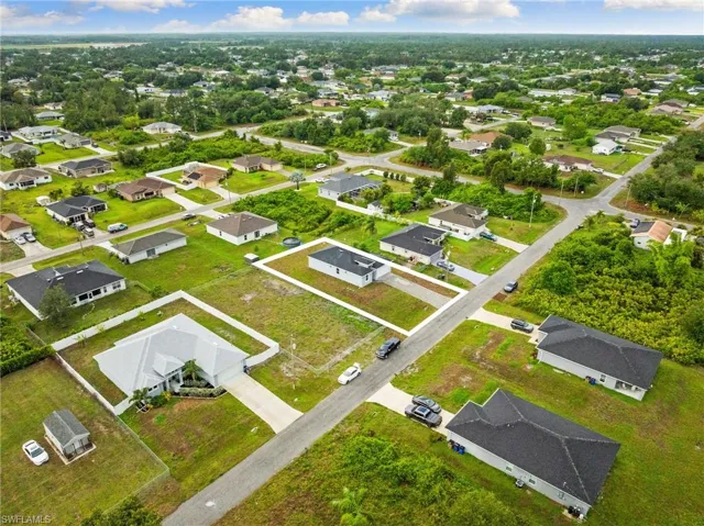 Aerial view of property and surrounding area with nearby suburban area and property boundaries highlighted