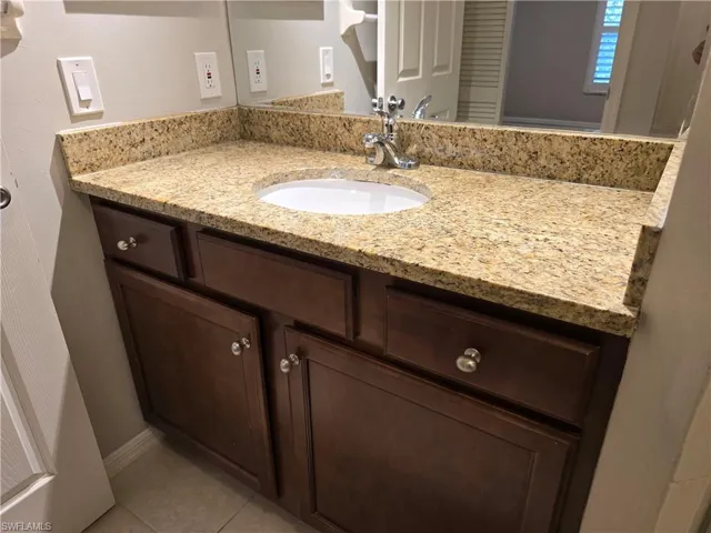 Bathroom featuring vanity and tile patterned flooring