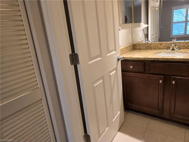 Bathroom featuring tile patterned floors and vanity