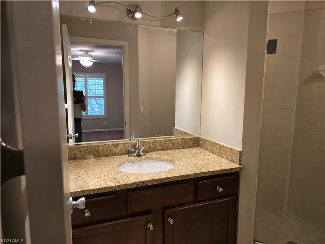 Full bath featuring vanity and a stall shower