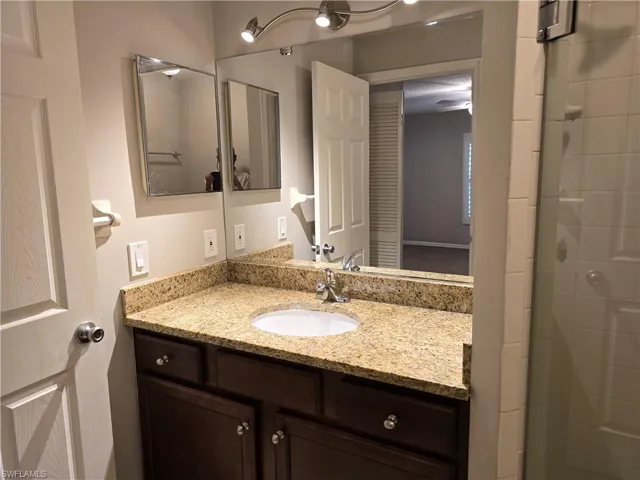 Full bath with vanity and a shower stall