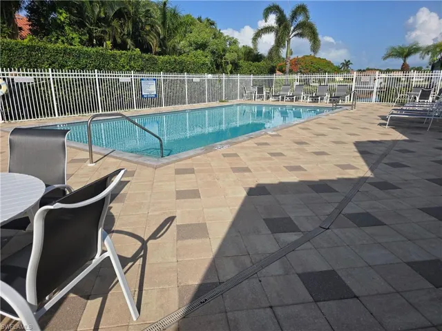 Community pool with a patio