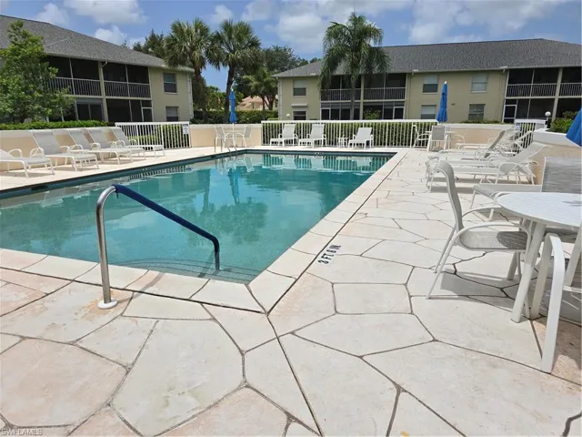 Community pool with a patio
