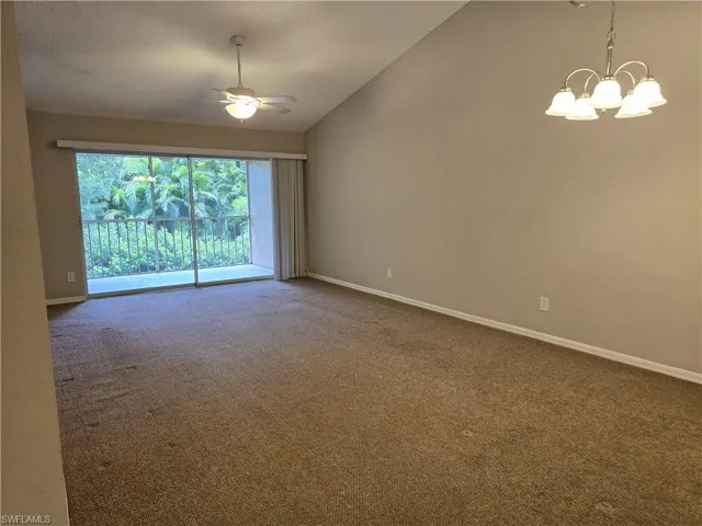 Living/Dining room featuring lofted ceiling, ceiling fan, a chandelier, and baseboards