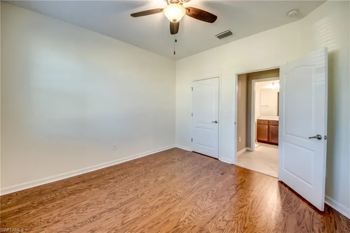 Unfurnished bedroom with light wood-style floors and ceiling fan