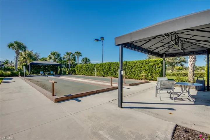 Surrounding community featuring a gazebo, a patio, and a game area