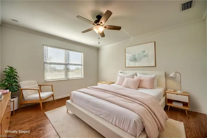Bedroom featuring crown molding, wood finished floors, and ceiling fan