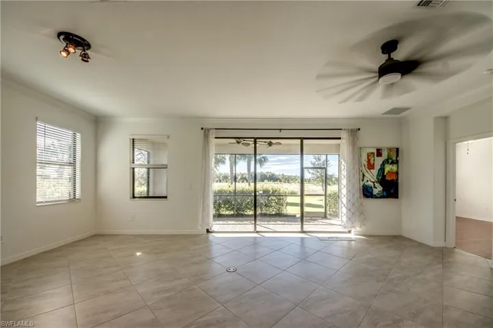 Unfurnished room featuring crown molding, ceiling fan, and light tile patterned floors