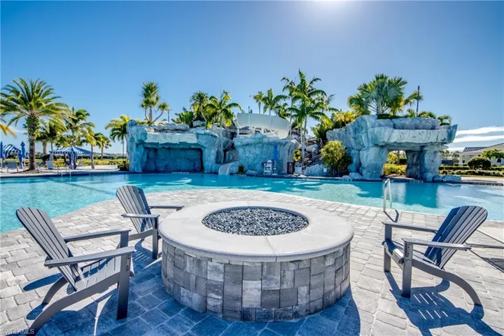 Community pool featuring a patio and a fire pit