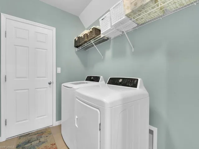 Washroom featuring washing machine and clothes dryer