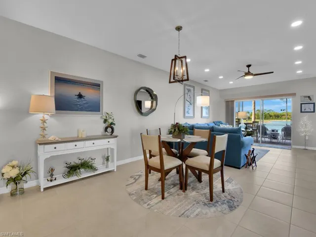 Tiled dining space featuring ceiling fan