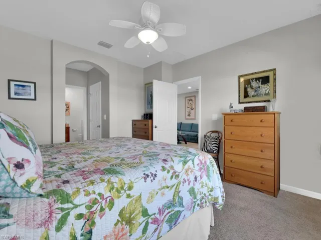 Bedroom featuring ceiling fan and carpet floors