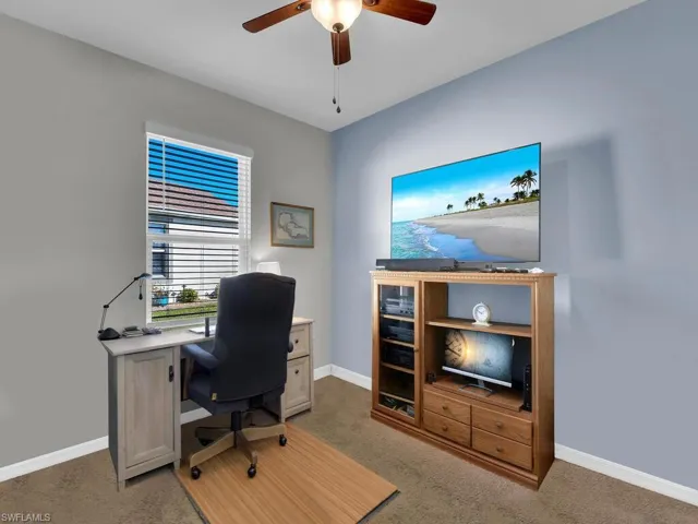 Carpeted home office with ceiling fan