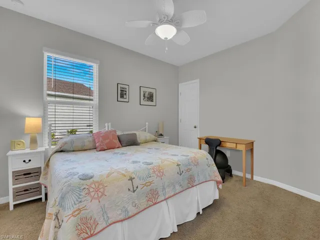 Carpeted bedroom with ceiling fan