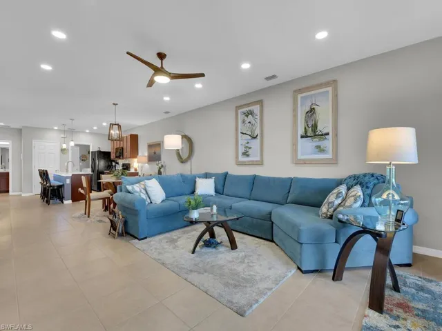 Tiled living room featuring ceiling fan