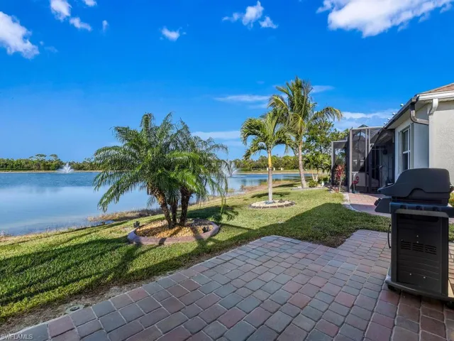 View of patio / terrace featuring a water view and a lanai