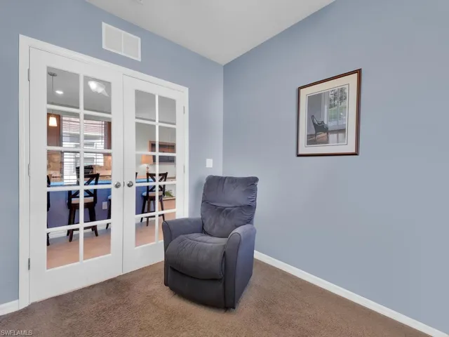 Sitting room with carpet flooring and french doors