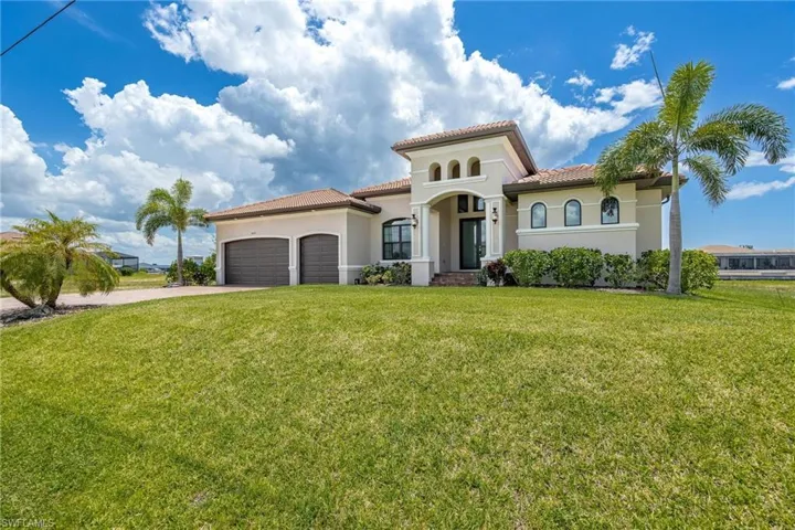 Mediterranean / spanish house featuring a garage and a front yard