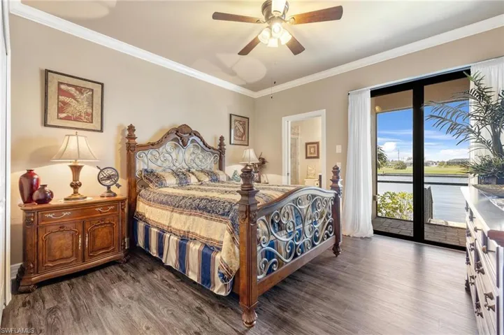 Junior Suite with crown molding, a water view, hardwood / wood-style flooring, ceiling fan, and access to exterior