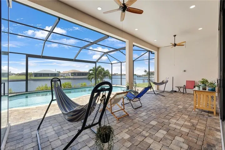 View of patio / terrace featuring a lanai and ceiling fan