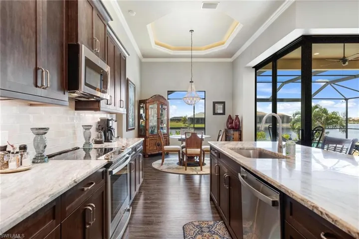 Kitchen featuring appliances with stainless steel finishes, sink, plenty of natural light, and dark hardwood / wood-style floors