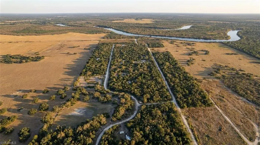 Expansive property featuring a combination of dense woodlands and open fields