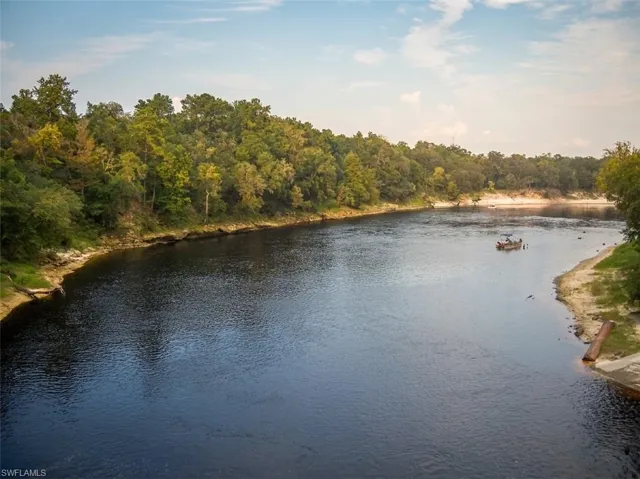 Riverfront property featuring extensive natural landscaping along the banks