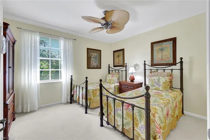 Guest bedroom #2 with beautiful natural light, crown molding, and ceiling fan/light!