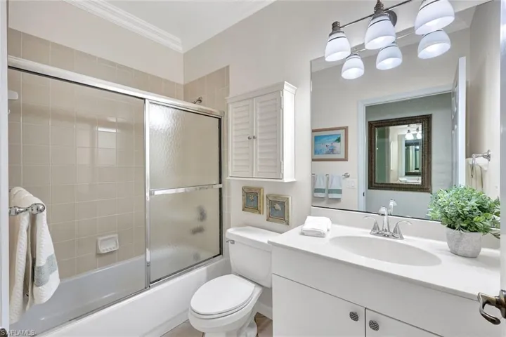 Guest bathroom with neutral finishes and crown molding!