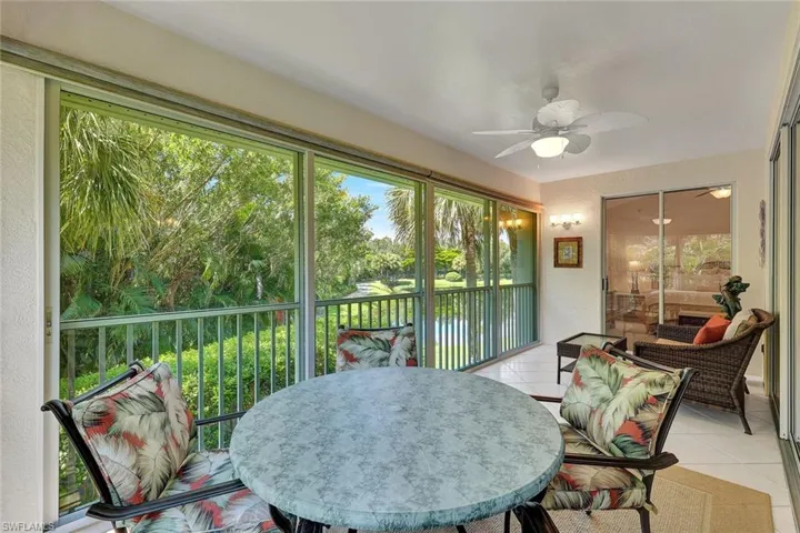Enclosed lanai with beautiful lush landscaping, water views and ceiling light/fan!