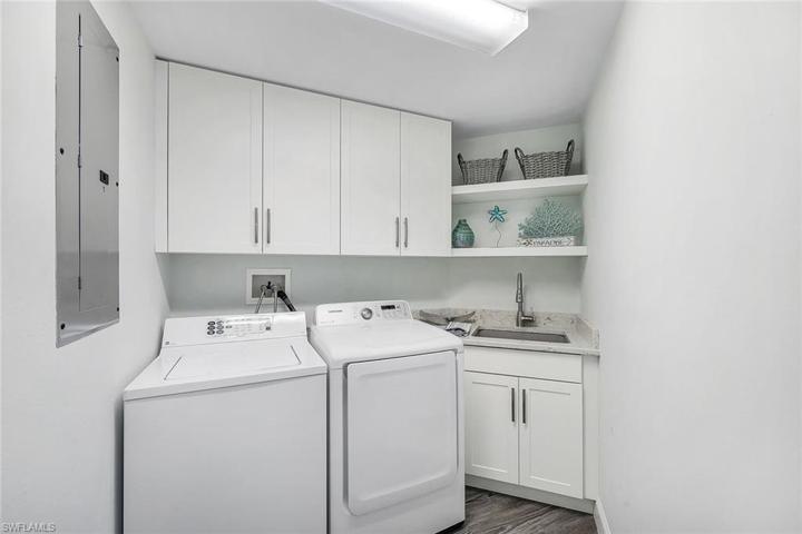 Shaker style cabinetry and utility sink in the laundry room.