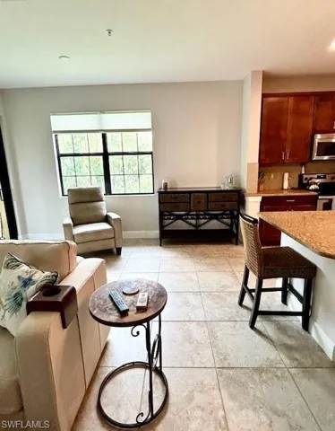 Living room featuring light tile floors