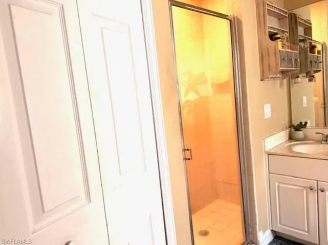 Bathroom with a shower stall and vanity