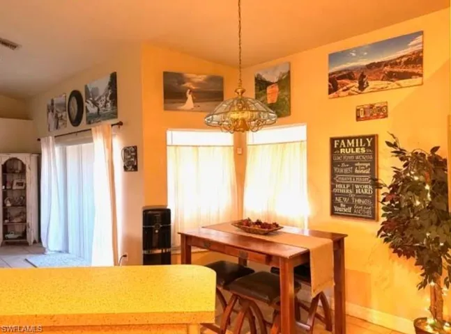 Dining area with baseboards and lofted ceiling