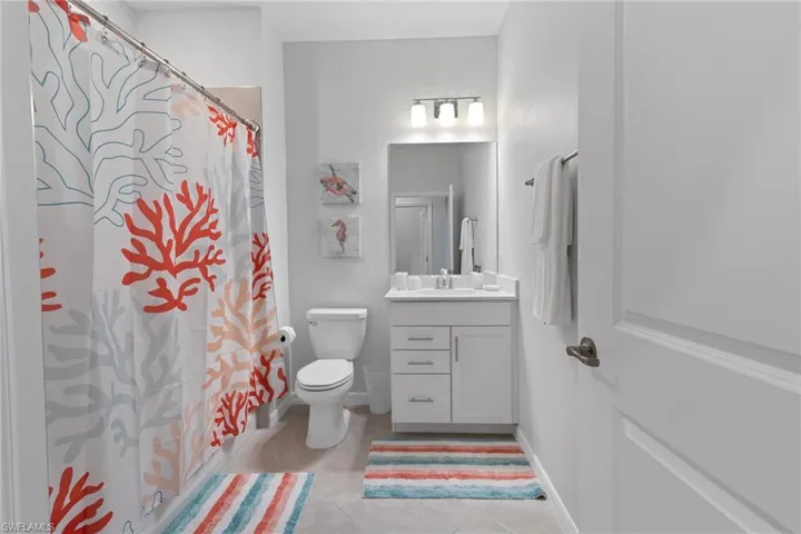 Bathroom with tile floors, oversized vanity, and toilet