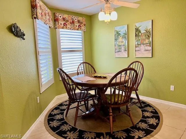 Dining room with ceiling fan and light tile patterned floors
