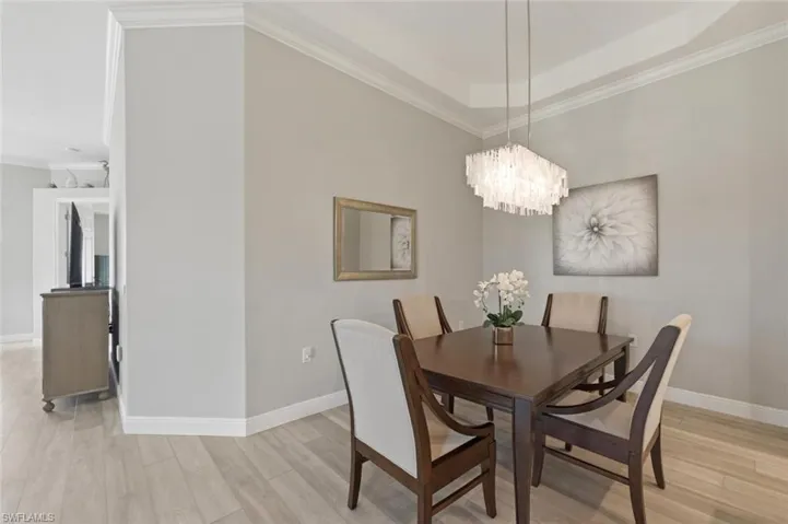 Tray ceiling with crown molding and a contemporary chandelier