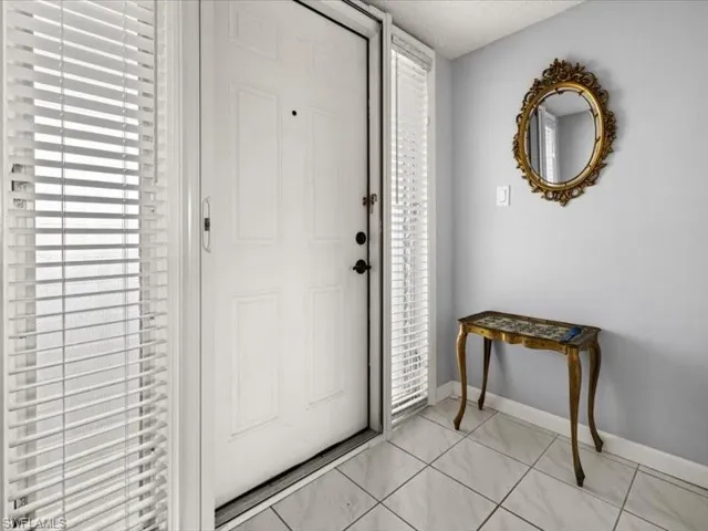 Foyer entrance with light tile patterned floors