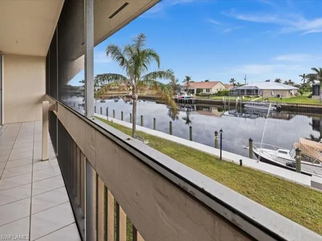 Balcony with a boat dock and a water view