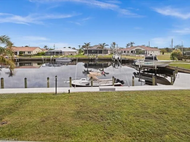 Dock area featuring a yard and a water view